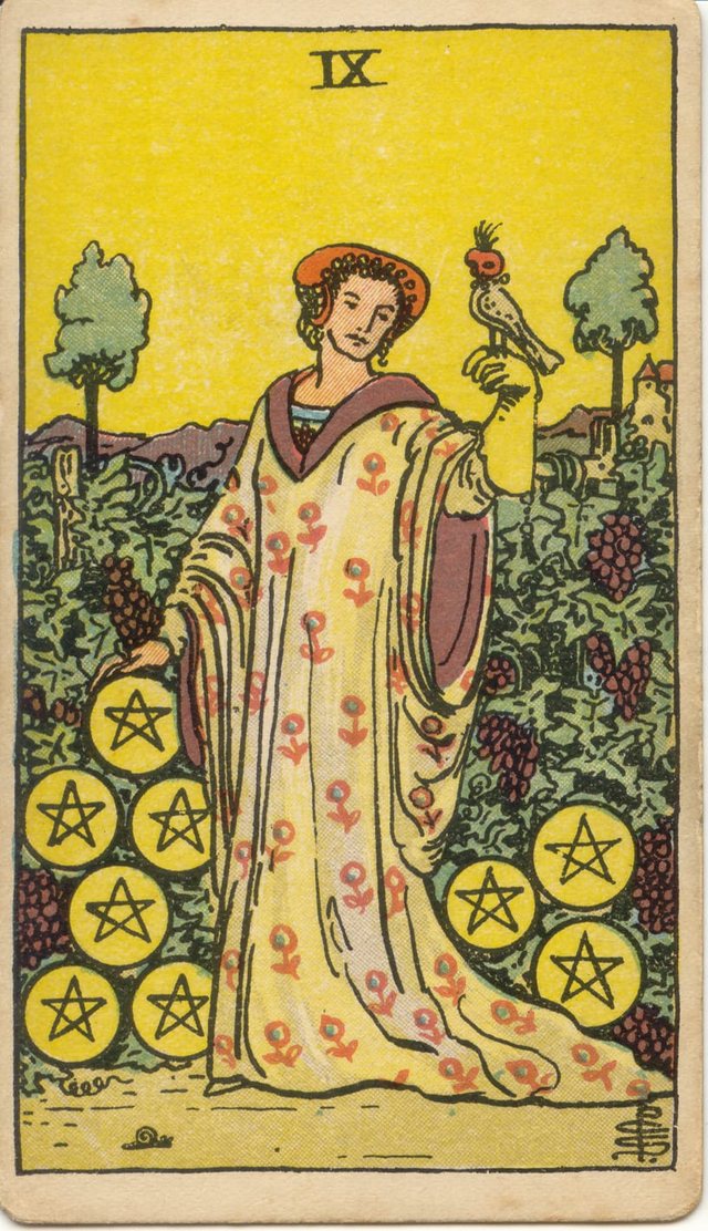Nine of Pentacles: The woman in the flowered robe, the hooded falcon, the grapes and vines, the pentacles. Rider–Waite–Smith tarot, 1909.