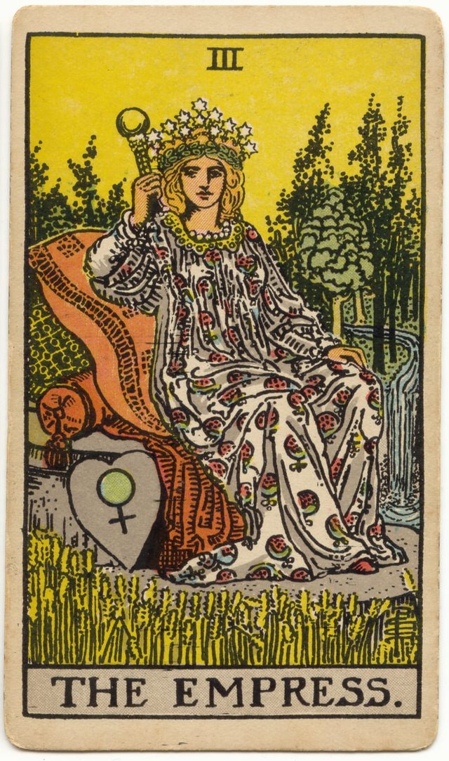 The Empress: The crown of stars, the venus shield, the sceptre and globe, the patterned gown. Rider–Waite–Smith tarot, 1909.