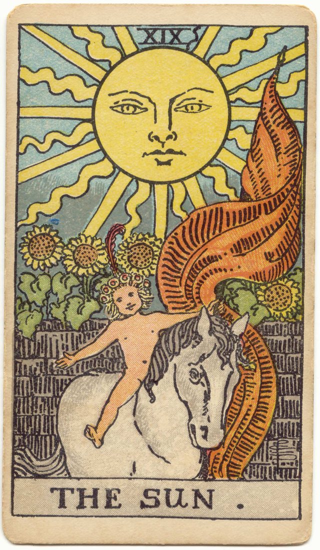 The Sun: The sun with a face, the naked child, the wreath and red feather, the white horse. Rider–Waite–Smith tarot, 1909.